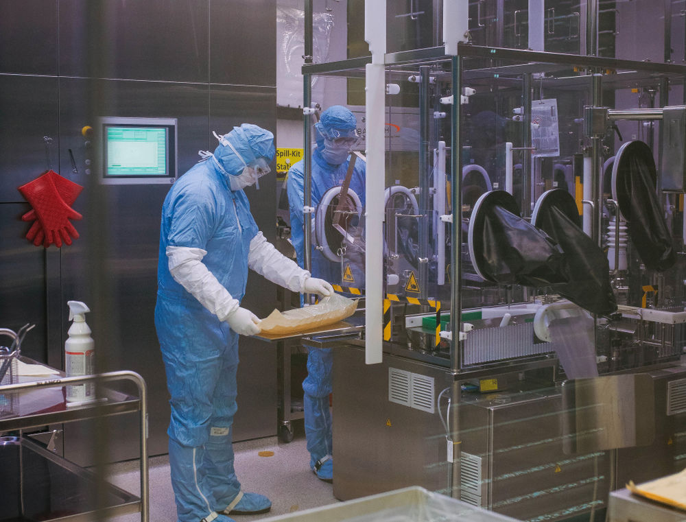 During production, the vaccine filling process can only be viewed from behind the glass pane. Employees Bjoern Dalichau and Andreas Mueller prepare the line for the filling of the SARS-CoV-2 vaccine candidate.